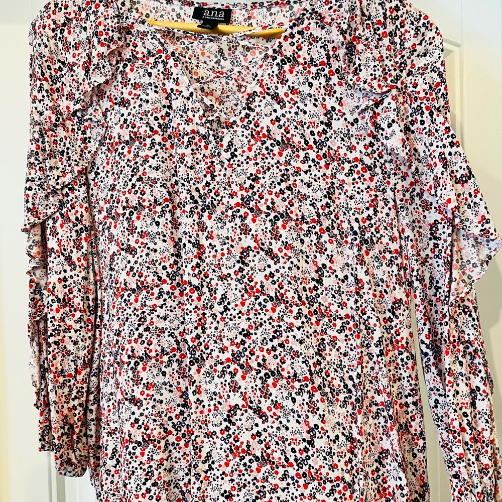 Medium, flowy print blouse with criss cross neckline.